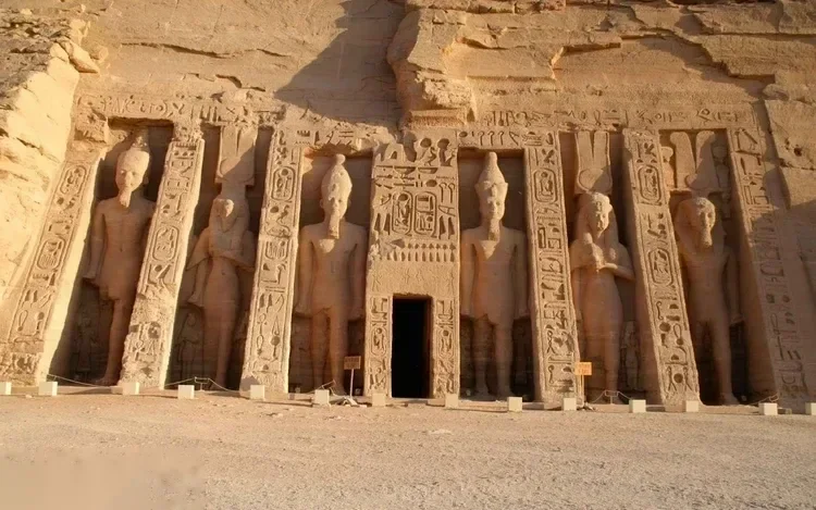 Facade of the smaller Temple of Hathor at Abu Simbel, carved with standing statues of Ramses II and Nefertari.